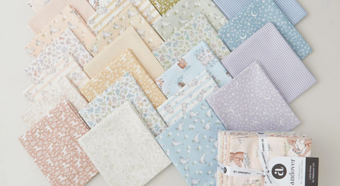 Fat quarter fabrics with prints of animals and coordinating designs in assorted soft shades.